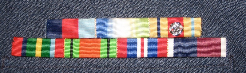 Ribbon medals: Top row: 1939-1945 Star, Atlantic Star, Africa Star (with North Africa 1942-43 clasp, for Navy service).
Second row: Pacific Star, Defence Medal, War Medal 1939–1945, RAF Long Service and Good Conduct.